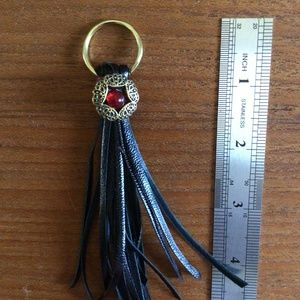Black leather tassel with red and gold bling